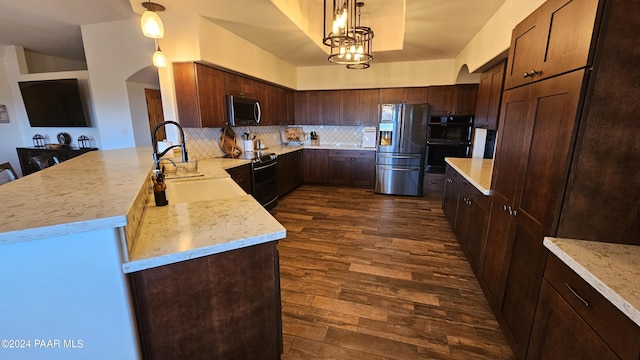 kitchen with sink, tasteful backsplash, dark hardwood / wood-style flooring, pendant lighting, and black appliances