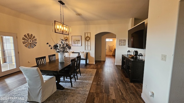 dining area with a chandelier and dark hardwood / wood-style flooring