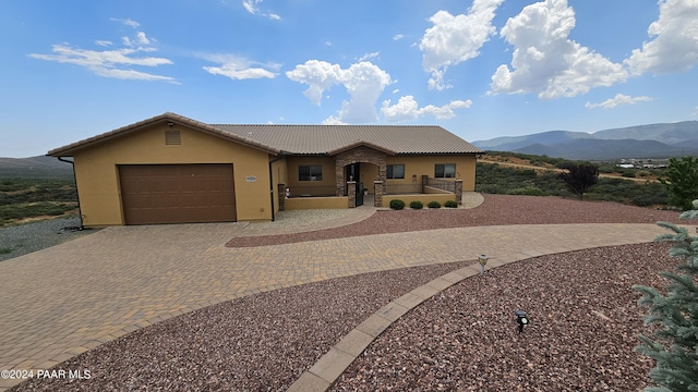 view of front of house featuring a mountain view and a garage