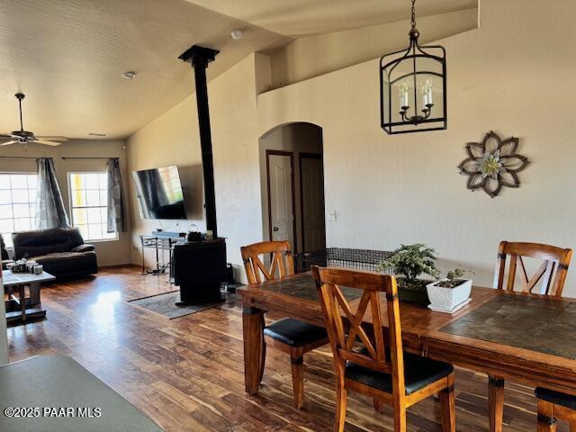 8183 N Blessing Ln, Prescott Valley, AZ 86315 - dining room featuring arched walkways, ceiling fan, wood finished floors, a chandelier, and high vaulted ceiling