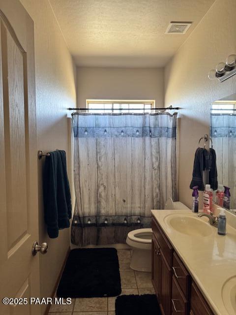 8183 N Blessing Ln, Prescott Valley, AZ 86315 - full bath featuring double vanity, tile patterned floors, shower / bath combination with curtain, and a textured ceiling