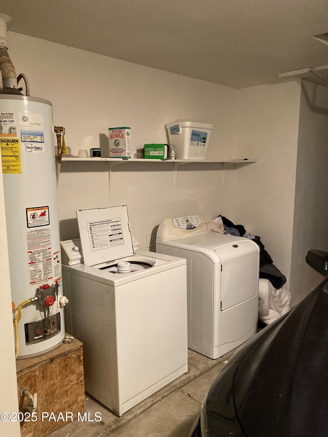 clothes washing area with washing machine and dryer and water heater