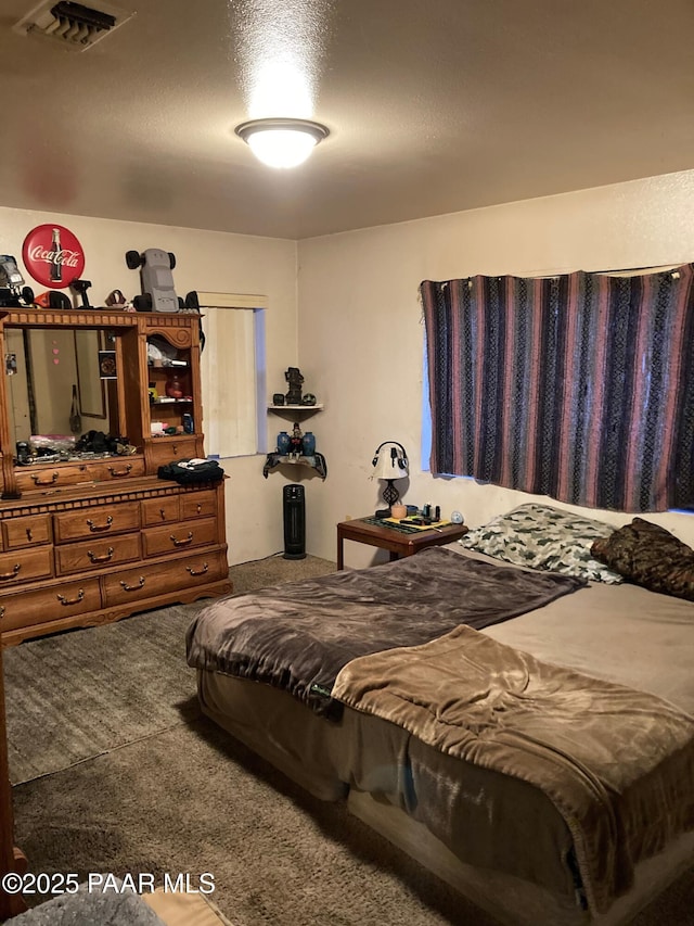 carpeted bedroom with a textured ceiling