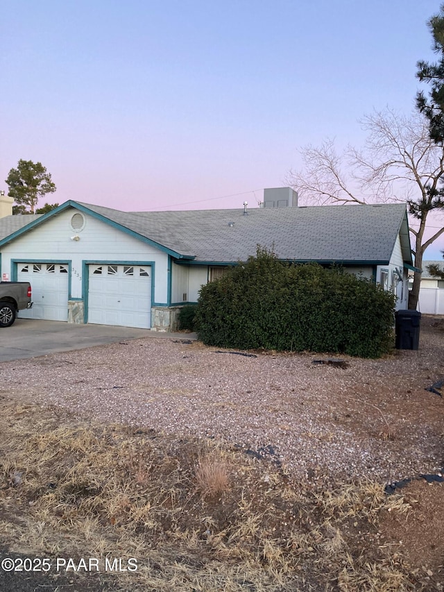 ranch-style home featuring a garage