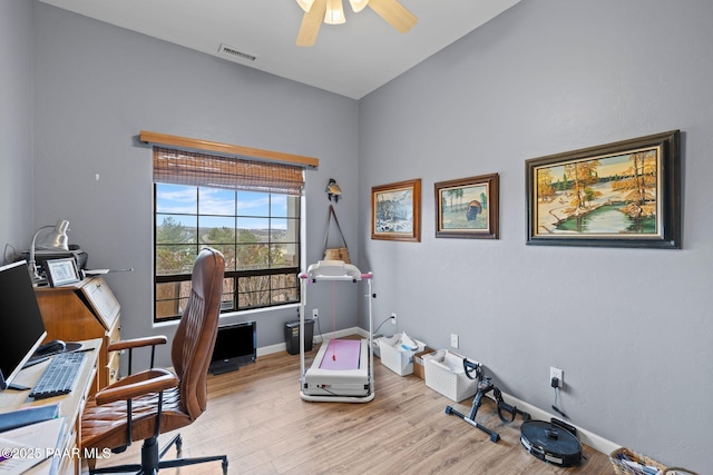 office area featuring light wood-type flooring, visible vents, baseboards, and a ceiling fan