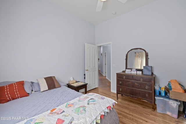 bedroom featuring baseboards, ceiling fan, and wood finished floors