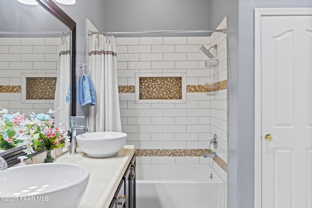 full bathroom with double vanity, shower / bath combo with shower curtain, and a sink