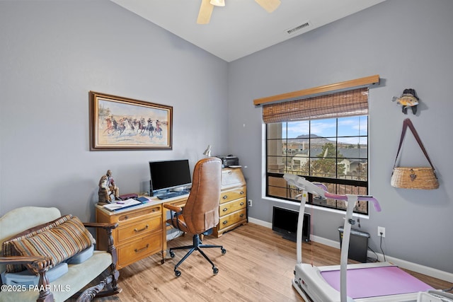 office space with light wood-type flooring, visible vents, baseboards, and a ceiling fan