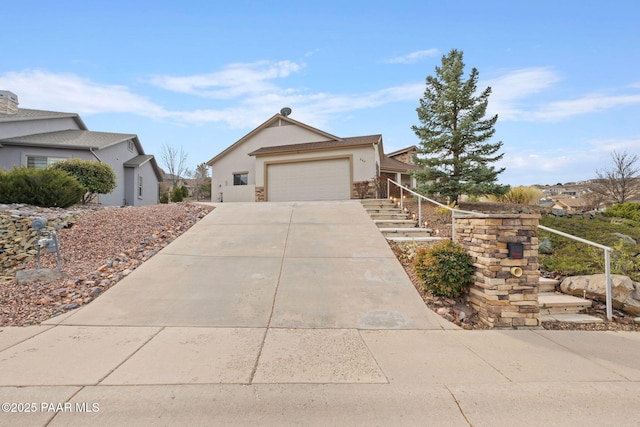 single story home featuring an attached garage, driveway, and stucco siding