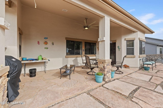 view of patio / terrace featuring a ceiling fan and visible vents