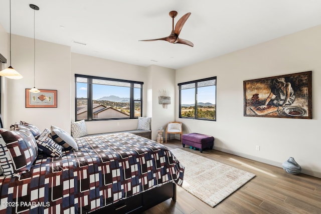 bedroom with hardwood / wood-style flooring and ceiling fan