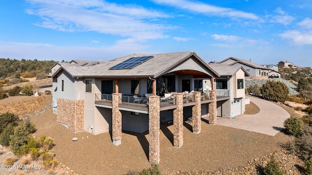 view of front facade with solar panels and a garage