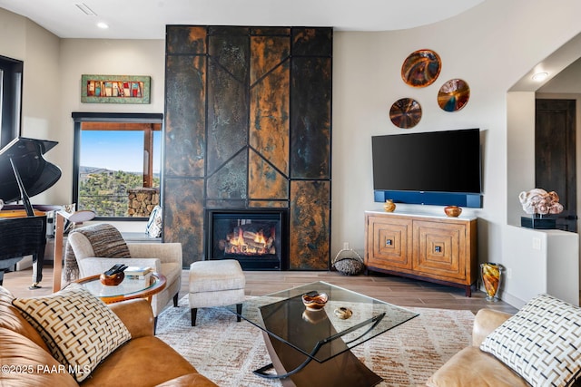 living room with a tile fireplace