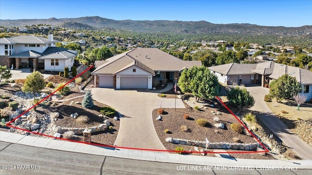 ranch-style home with a mountain view and a garage