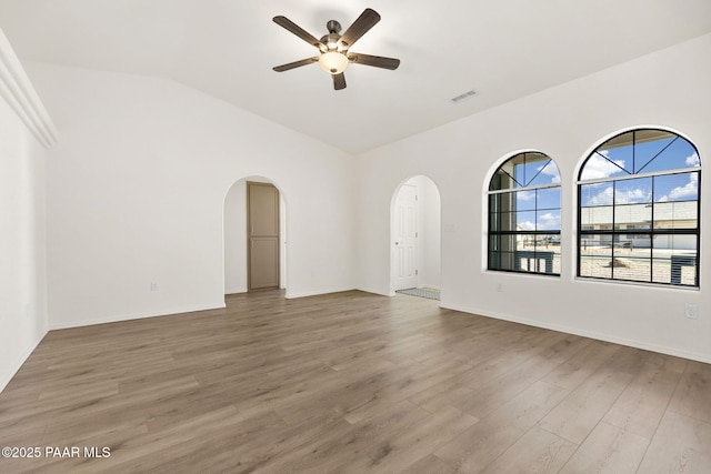 unfurnished room featuring ceiling fan, wood-type flooring, and lofted ceiling