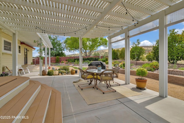 view of patio / terrace featuring a fenced backyard, outdoor dining space, and a pergola