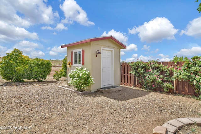 view of shed featuring fence