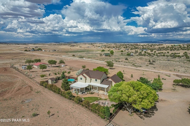 drone / aerial view with a mountain view, a desert view, and a rural view