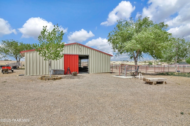view of pole building featuring an exterior structure and fence