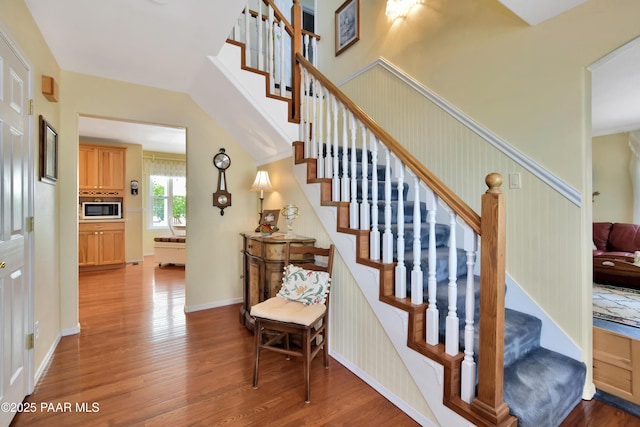 stairway featuring baseboards and wood finished floors