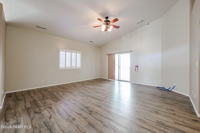 spare room featuring ceiling fan, hardwood / wood-style floors, and high vaulted ceiling