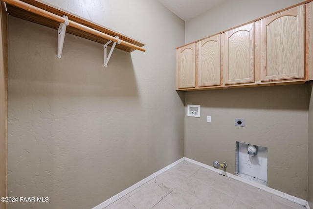 laundry area with cabinets, hookup for a washing machine, electric dryer hookup, light tile patterned floors, and hookup for a gas dryer