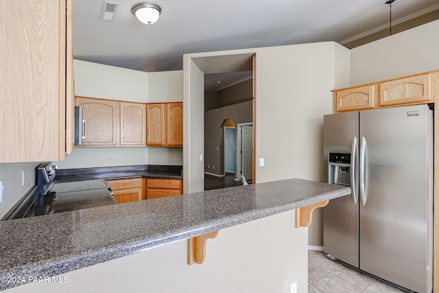 kitchen with a kitchen breakfast bar, light brown cabinets, light tile patterned flooring, and appliances with stainless steel finishes