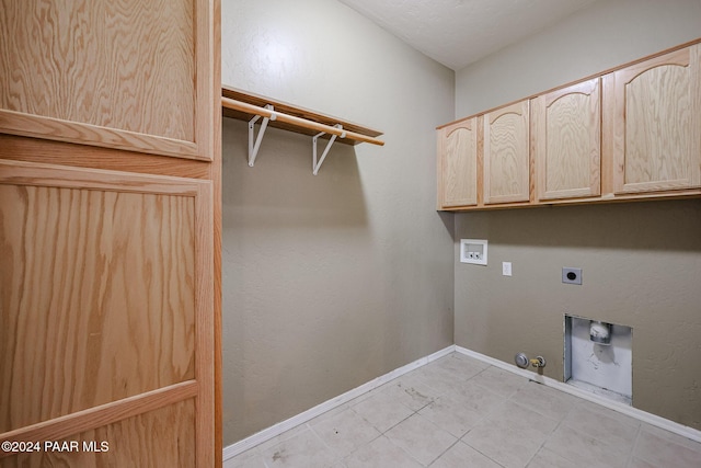 laundry area featuring hookup for an electric dryer, washer hookup, cabinets, gas dryer hookup, and light tile patterned floors