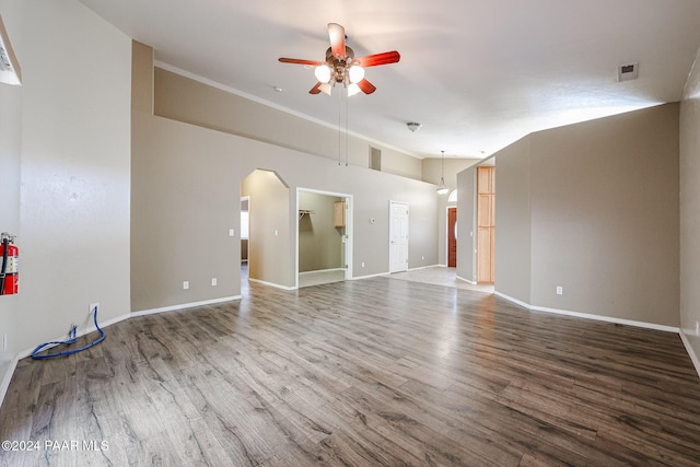 unfurnished living room featuring ceiling fan, wood-type flooring, and vaulted ceiling