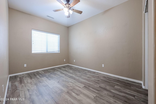 unfurnished room with hardwood / wood-style floors and ceiling fan