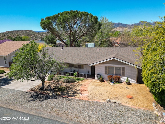 ranch-style home featuring covered porch and a mountain view