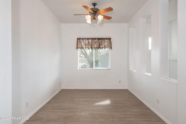 empty room featuring light wood-type flooring and ceiling fan