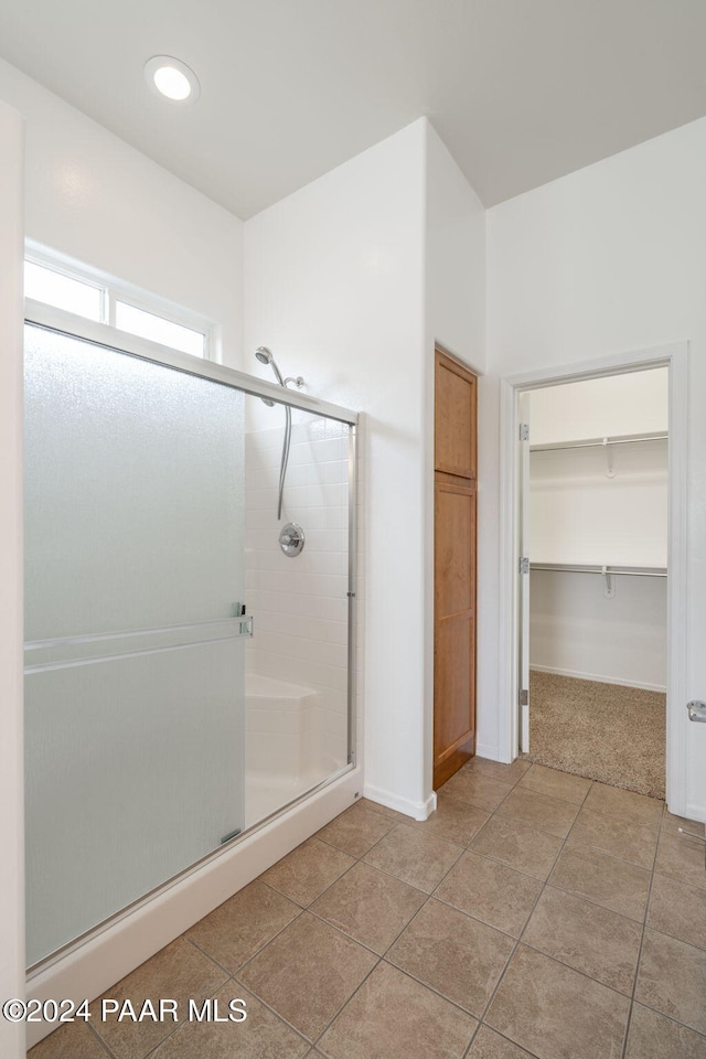 bathroom featuring tile patterned flooring and a shower with door