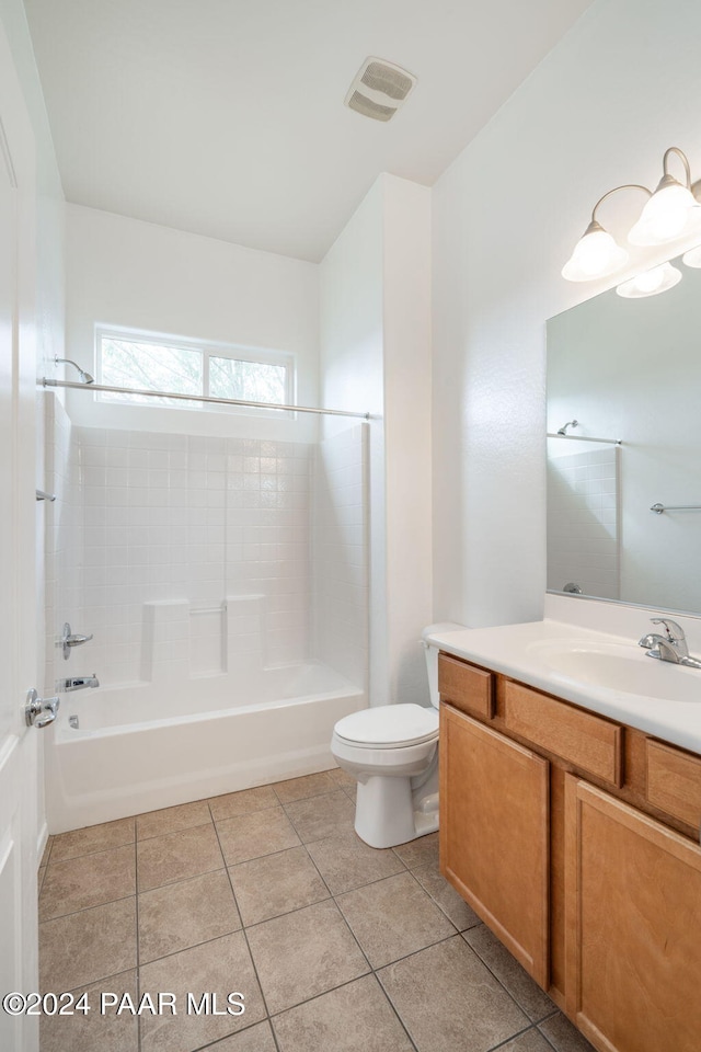 full bathroom with toilet, vanity, tile patterned floors, and tiled shower / bath combo