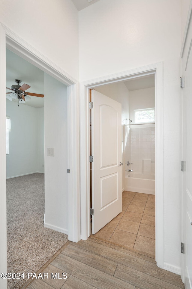 hallway with light hardwood / wood-style flooring