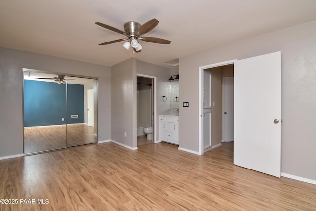 3035 Hozoni Rd, Prescott, AZ 86305 - unfurnished bedroom with light wood-style floors, connected bathroom, and a ceiling fan
