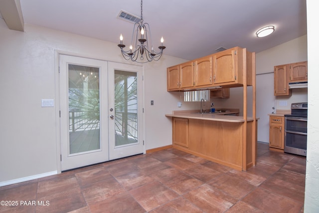 3035 Hozoni Rd, Prescott, AZ 86305 - kitchen featuring double oven range, a chandelier, french doors, light countertops, and under cabinet range hood