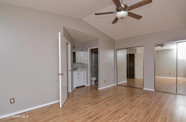 3035 Hozoni Rd, Prescott, AZ 86305 - unfurnished bedroom with two closets, light wood-style flooring, lofted ceiling, and connected bathroom