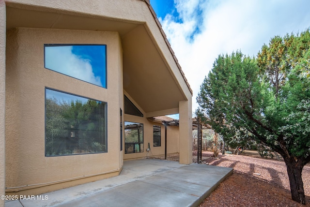 back of house with a patio area and stucco siding