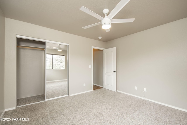 unfurnished bedroom with a closet, carpet flooring, a ceiling fan, and baseboards