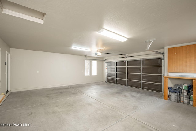 garage featuring baseboards and a garage door opener