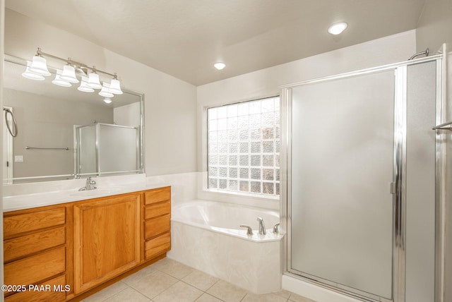 bathroom with tile patterned flooring, a shower stall, vanity, and a garden tub