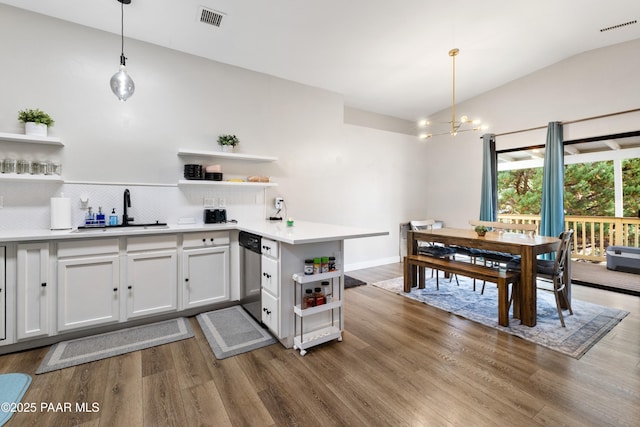 4714 N Sheridan Ln, Prescott Valley, AZ 86314 - kitchen with open shelves, lofted ceiling, wood finished floors, dishwasher, and a peninsula