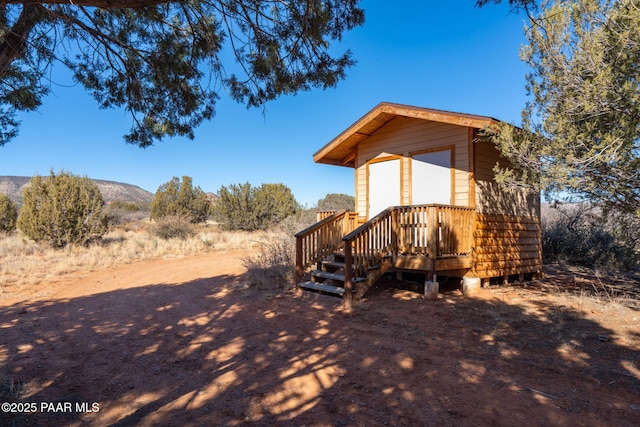 exterior space featuring a mountain view and an outdoor structure