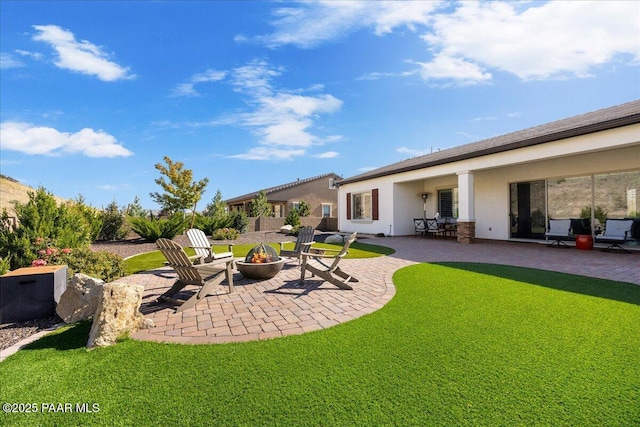 view of yard with a patio and an outdoor fire pit