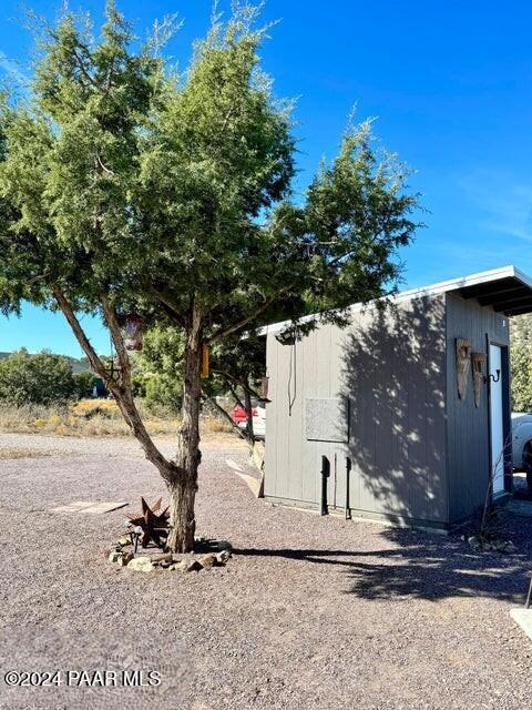 view of side of home with a shed