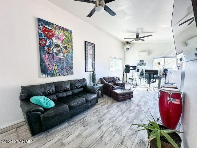 living room with ceiling fan, an AC wall unit, a wealth of natural light, and light hardwood / wood-style flooring