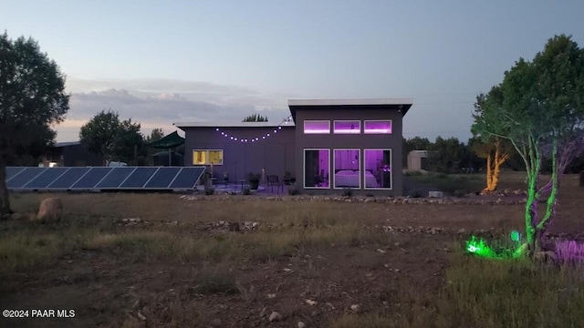 back house at dusk with solar panels