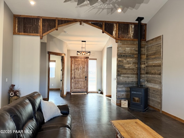 living room with beamed ceiling, a wealth of natural light, high vaulted ceiling, and a wood stove