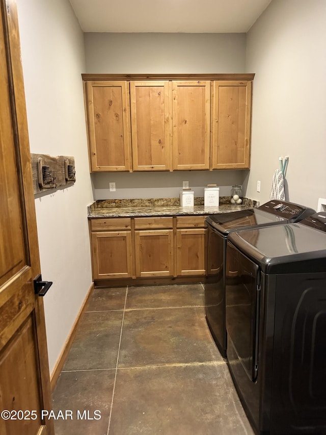 laundry room with cabinets and washing machine and clothes dryer